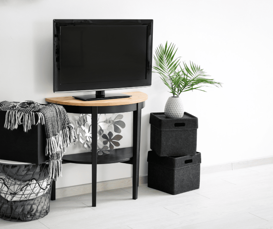 TV on a coffee table pushed onto a wall