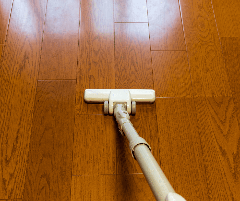 White vacuum cleaner on vinyl plank flooring