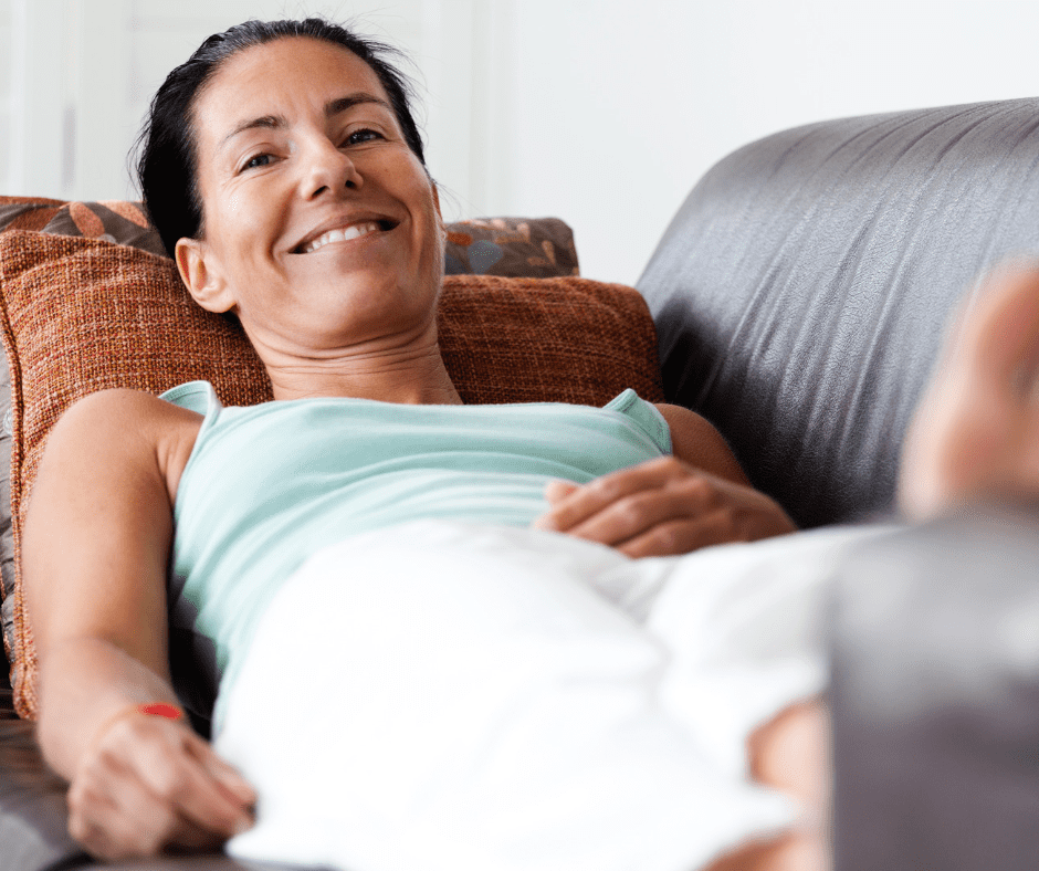 Woman lying on leather couch