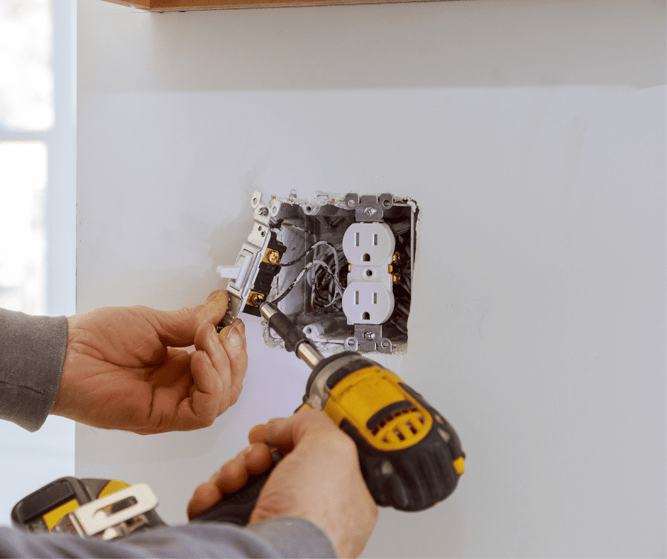 Man fixing an electrical outlet