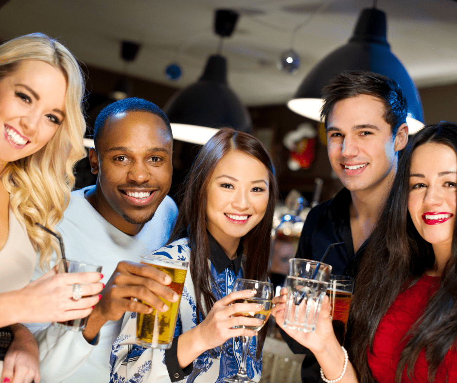 Friends having a great time together in a home with a personal bar