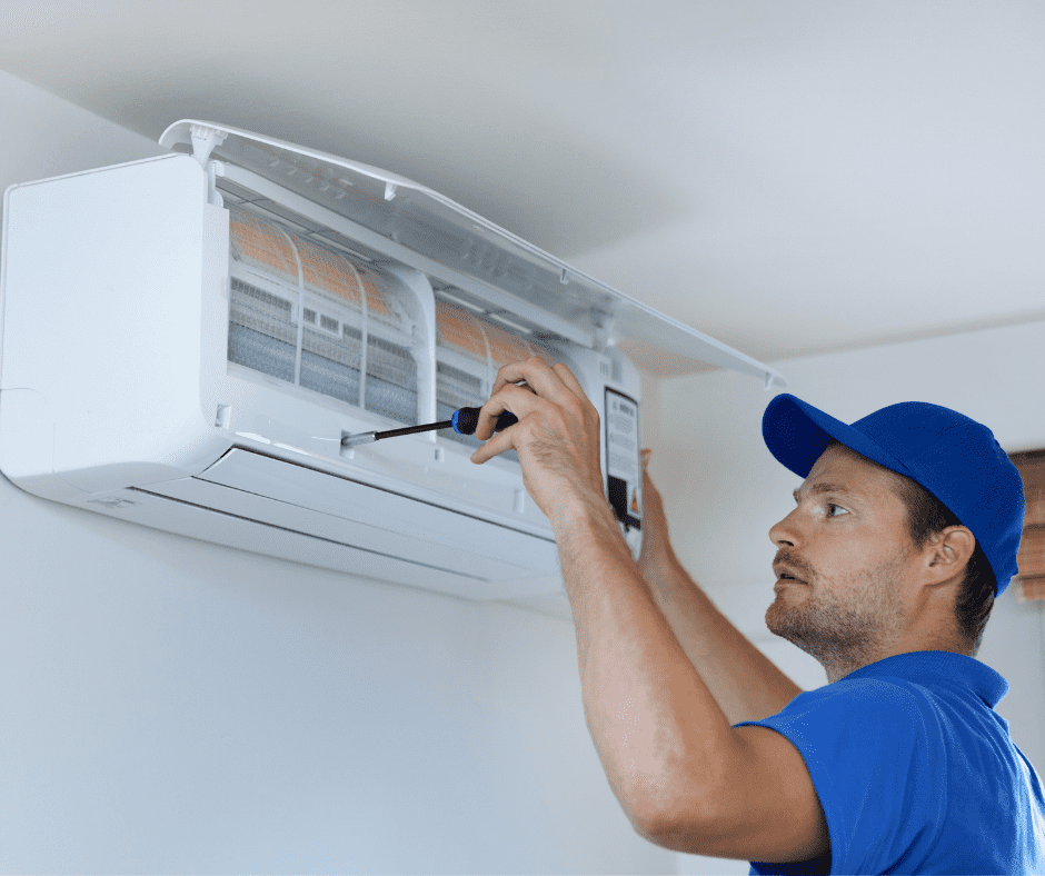 Man fixing a split-type air conditioner