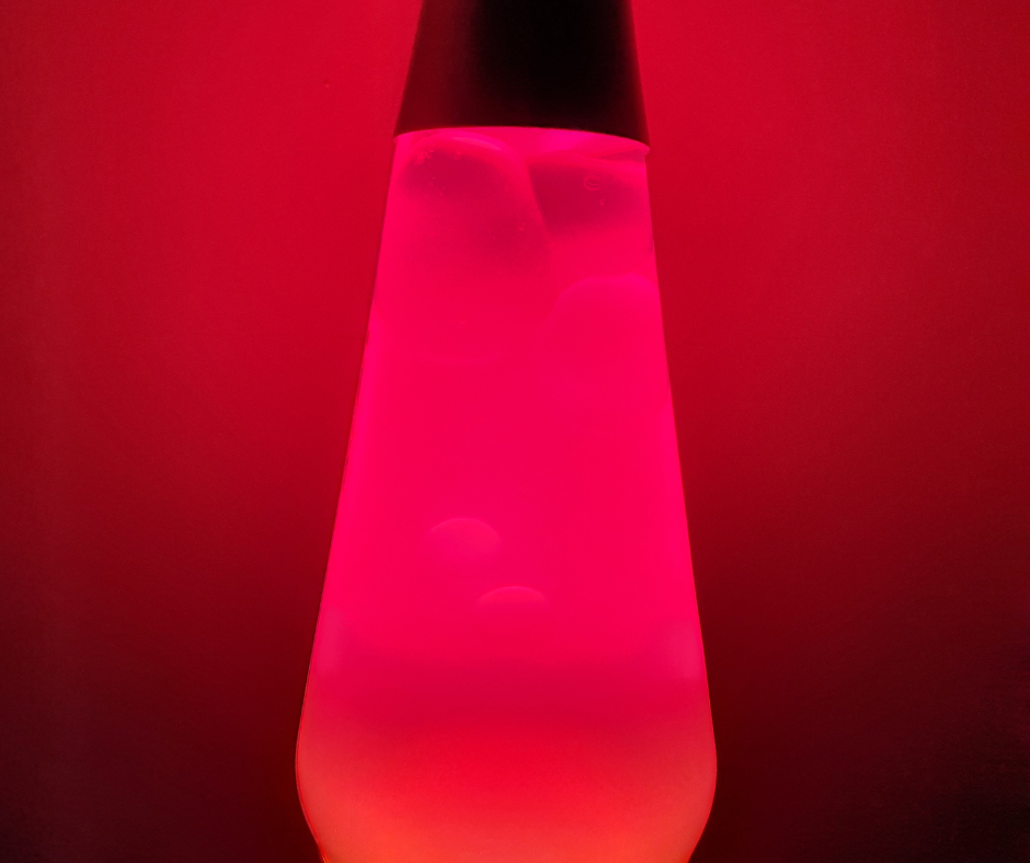 Pink lava lamp on red background