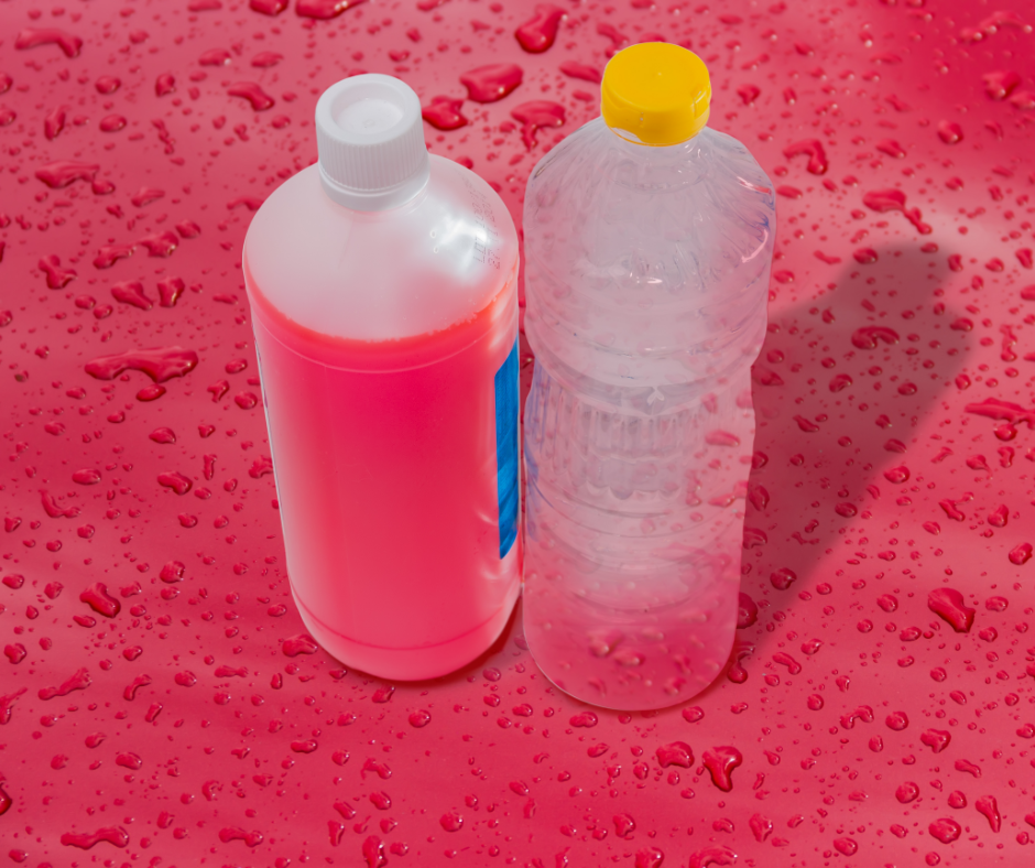 A bottle of coolant beside a bottle of water