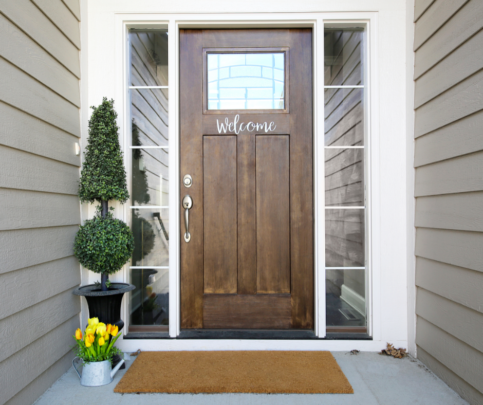 A front door that's painted close to the shade of llama wool.