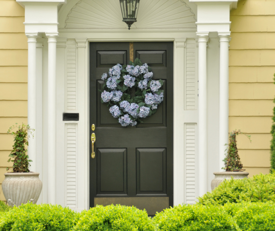 A front door that's painted in the shade of sage green.