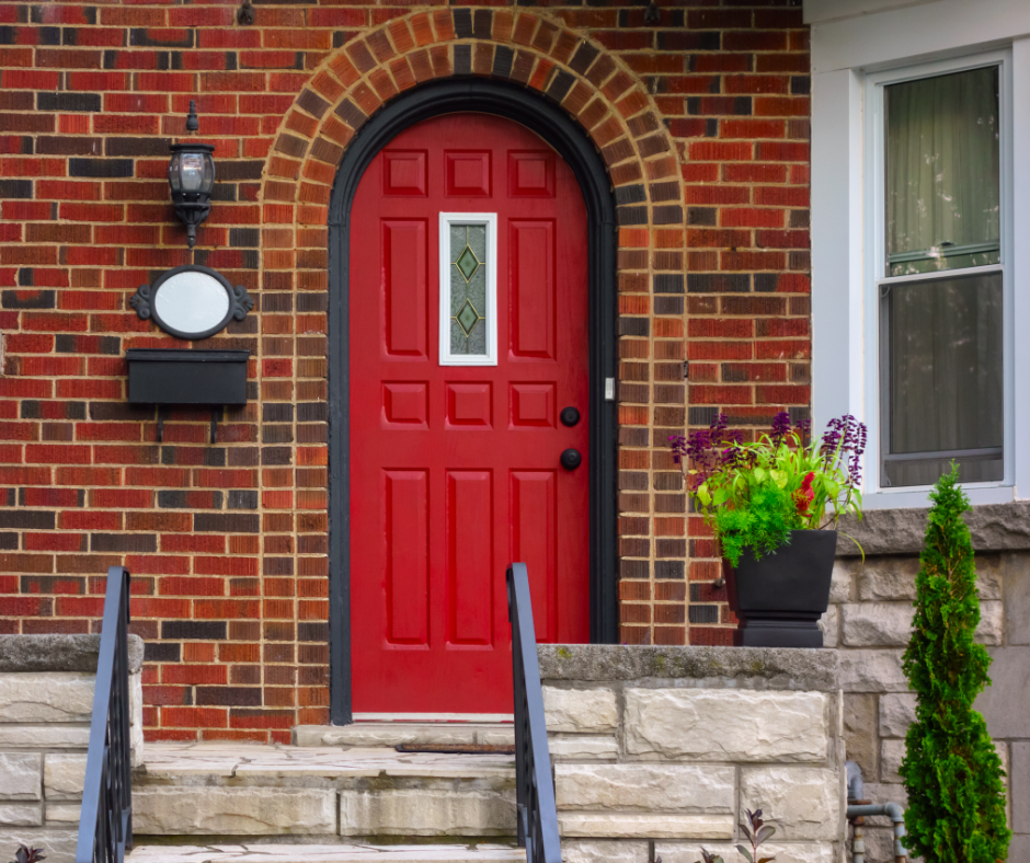 A front door that's painted close to the shade of positive red.