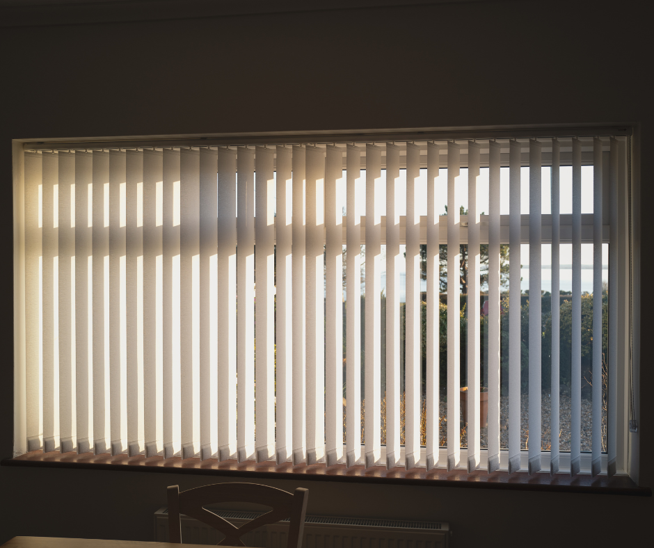 Vertical blinds barely letting in sunlight