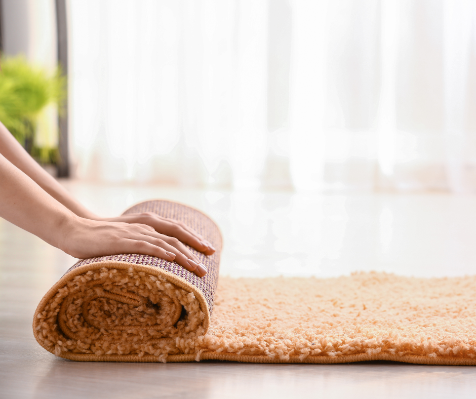 Rolling a rug on wooden floor