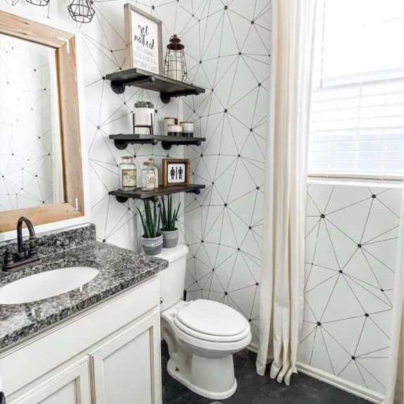 country bathroom with geometric wall paper and rustic shelf