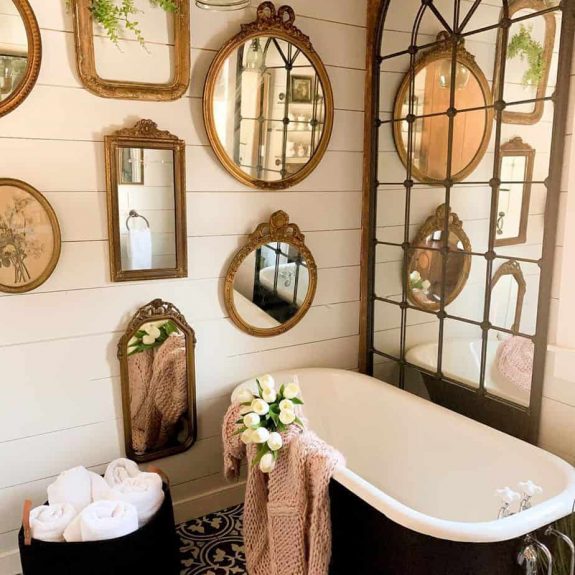 country bathroom idea with vintage mirrors shiplap wall and black bath tub