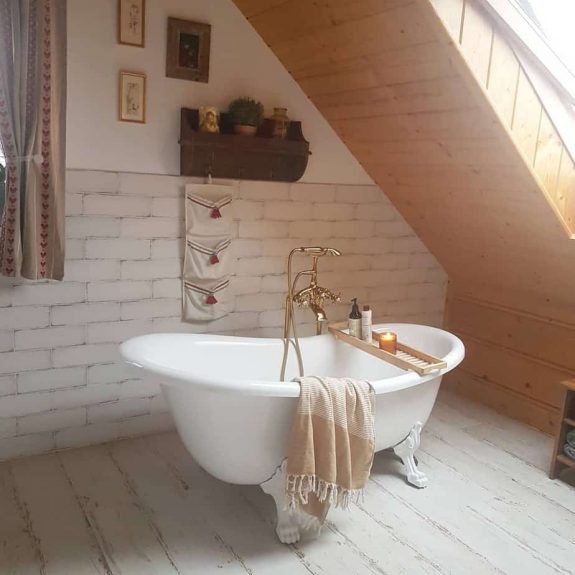 country bathroom with bath tub under natural lighting